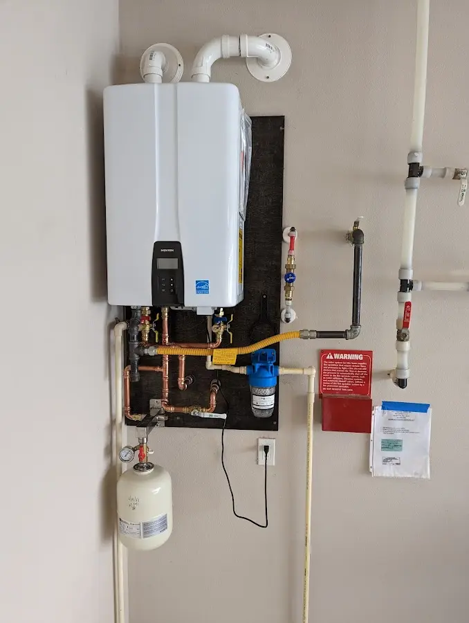 Professional plumber installing copper piping in a Midlothian home